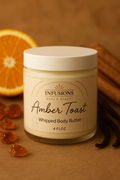 Jar of Infusions Amber Toast Whipped Body Butter with vanilla beans and orange slices on a brown background